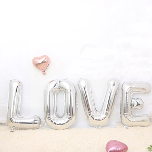 32-inch silver LOVE foil balloons set with pink heart accents for romantic parties