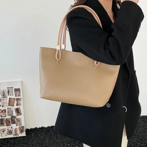 Minimalist large khaki tote bag with dual shoulder straps and gold metal hardware