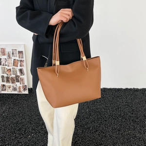 Brown large capacity leather tote bag with long shoulder straps and gold hardware for women