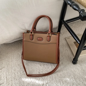 Detail of two-tone brown tote bag with premium stitching on textured PU leather