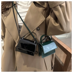 Close-up of micro patent leather flap handbags with handles and slender shoulder straps