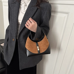 Two-tone brown suede and black leather hobo bag with a golden metal twist lock clasp