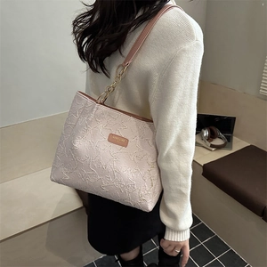 Fashionable light pink large tote bag with star pattern quilting and brown leather straps