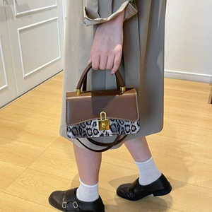Vintage-style leopard print crossbody bag with gold padlock and hourglass curved base