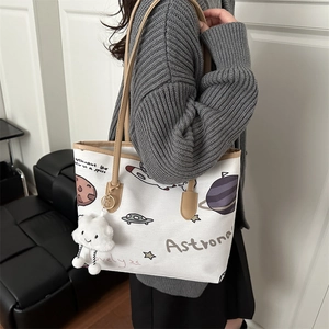 Cute white canvas tote bag with space illustrations and brown leather handles