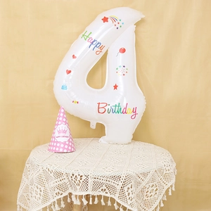 Detail of white number 4 balloon with colorful Happy Birthday prints and party hat