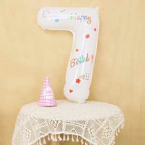 Detail of white number 7 birthday balloon with colorful stars and a pink party hat