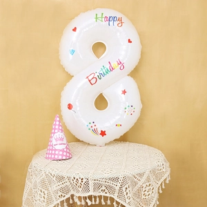 Detail of white number 8 balloon with Happy Birthday print and party accessories