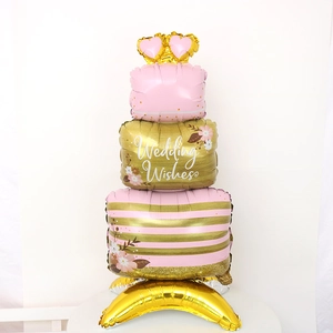 Macro view of tiered wedding cake foil balloon with crown and Wedding Wishes text
