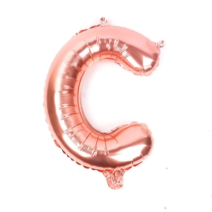 Macro detail of rose gold letter C foil balloon with metallic finish and hanging hole