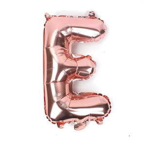 Detail of rose gold letter E foil balloon showing metallic texture and hanging holes