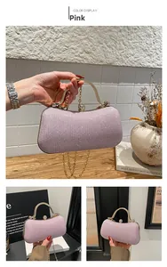 Close-up of pink glitter evening bag featuring a gold circular handle and crystal ball clasp