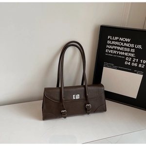 Detail view of large dark brown retro shoulder bag with silver twist lock and strap accents