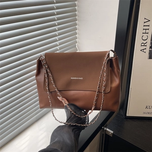 Minimalist brown leather underarm bag with metal chain strap and fashion print