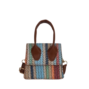 Ethnic style woven crossbody bag with colorful stripes and brown leather straps