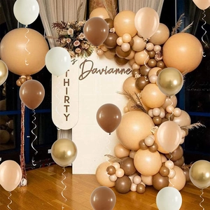 Detail of coffee and cream balloon arch with customized name board for birthday party décor
