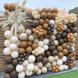 Bohemian balloon arch kit with earth tones and dried palm leaves for outdoor party decor