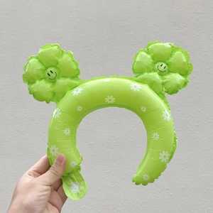 Green inflatable daisy flower headband with smiling face prints for party decoration