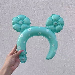 Detail of mint green inflatable daisy headpiece with smiley face flower petals for kids