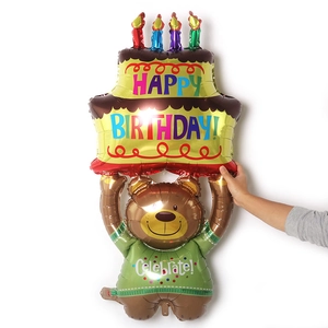 Detail of large foil balloon showing a brown bear holding a multi-layer birthday cake