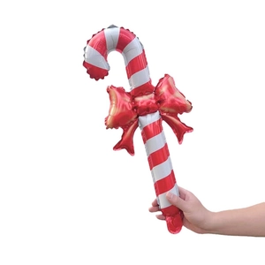 Christmas candy cane foil balloon with red bow held in hand for party props