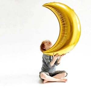 Large 36-inch gold moon foil balloon held by a child for wedding and party decoration