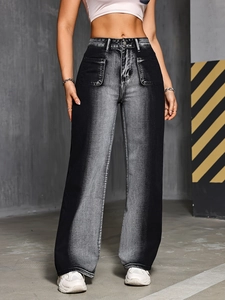 Macro shot of high waist jeans featuring large front patch pockets and faded black wash