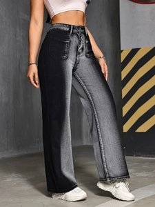 Detail shot of high-waisted black-to-grey gradient jeans with large cargo patch pockets