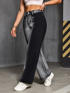 Detail of high-waisted wide-leg jeans with symmetrical square pockets and contrast wash
