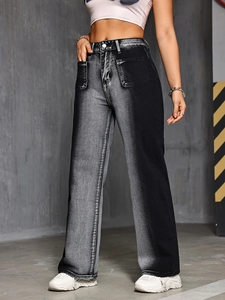 Detail of high waisted wide leg jeans with vintage black and grey gradient wash finish