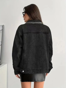 Close-up of black washed denim jacket featuring silver square stud details on the collar