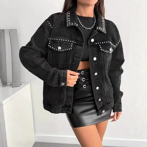 Fashionable black denim jacket with silver studs and metal buttons worn by a model