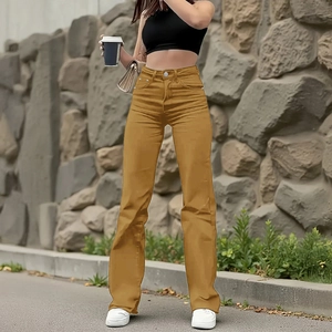 Detail shot of high-waist ginger yellow straight-leg jeans with metal button and zip fly
