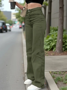 Street style view of olive green high-waisted wide-leg denim jeans on a city background
