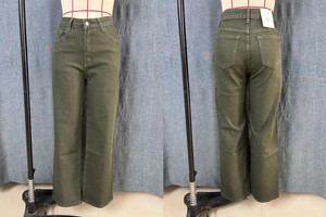 Detail of olive green high-waisted straight jeans with pockets and button closure