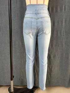Detail view of high waist skinny blue jeans with stretchy fabric and back pockets