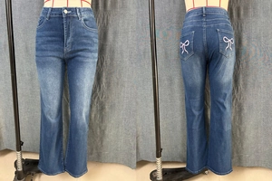 Front and back view of blue flared high-waist jeans with pink butterfly embroidery details