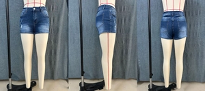 Three-way view of distressed dark blue denim shorts with whiskers and frayed hems