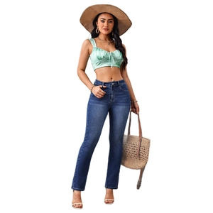 Slim fit denim jeans and green drawstring satin top set with casual holiday accessories