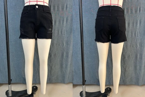 Detailed front and back view of black ripped denim shorts with frayed edges and distressed side