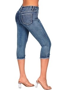 Detail view of frayed hem and vintage wash on slim fit denim mid-length jeans