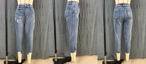 Detailed views of light blue ripped denim shorts with frayed edges and high waist design