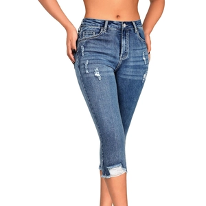 Slim fit ripped capri jeans for women in dark blue wash with frayed hem and stretch denim