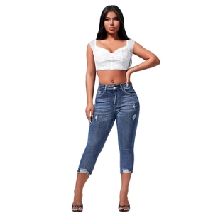 Slim fit ripped denim shorts and white lace tube top set for women street style look