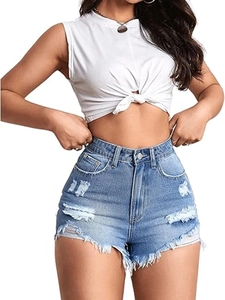 Detail of light blue distressed denim shorts with ripped fraying and irregular raw hems