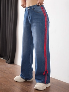 Women's high waist wide leg jeans in blue wash with red side stripes and ankle bows