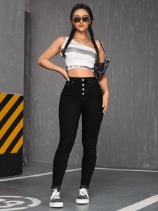Close-up of black high-waisted skinny jeans featuring a five-button fly front design