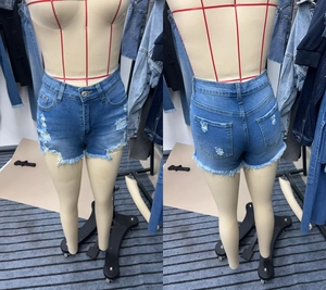 Front and back view of blue distressed denim shorts with ripped details and raw hem