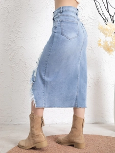 Women's vintage light blue denim midi skirt with distressed side rips and raw fringe hem