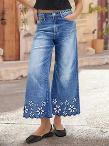Light blue wide-leg jeans with daisy floral embroidery and scalloped hem on the ankles